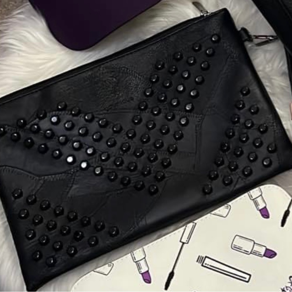 Brand new studded black clutch/crossover bag! Used as a clutch or crossover bag!